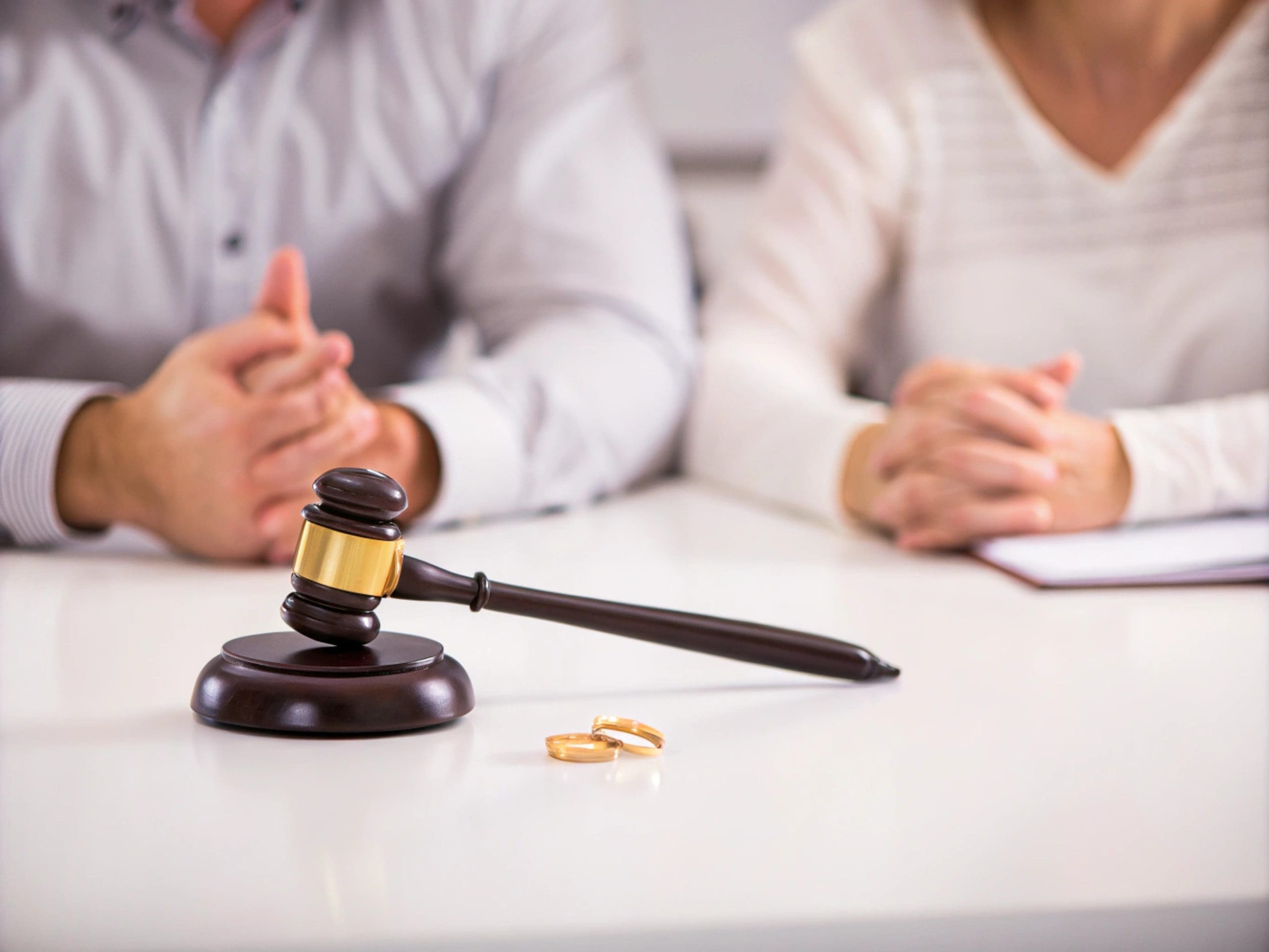 Divorce Proceedings Discussion with Gavel and Wedding Rings generative ai